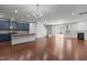 Bright open-concept living space featuring hardwood floors, a fireplace, and sliding glass doors to the exterior at 150 Alamosa Pl, Cary, NC 27519