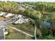 Aerial view of the property showcasing backyard pond, pool, patio, and mature trees at 1527 Ingraham Dr, Apex, NC 27502