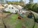 Aerial view of backyard featuring patio, playset, and beautifully landscaped yard at 1527 Ingraham Dr, Apex, NC 27502