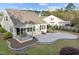 Aerial view of backyard showcasing patio, covered porch, and well-manicured landscaping at 1527 Ingraham Dr, Apex, NC 27502