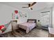 Bedroom with ceiling fan and polka dot bedding is decorated with colorful wall art at 1527 Ingraham Dr, Apex, NC 27502