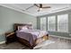 Bedroom with ample natural light, wood flooring, tray ceiling, and a king size bed at 1527 Ingraham Dr, Apex, NC 27502