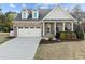 Charming brick home with a two-car garage, front porch, and well-maintained landscaping at 1527 Ingraham Dr, Apex, NC 27502