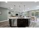 Kitchen island with stainless steel dishwasher, dark cabinetry, white countertop, and pendant lighting at 1527 Ingraham Dr, Apex, NC 27502