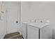 A functional laundry room featuring a washer, dryer, and door to the exterior at 1527 Ingraham Dr, Apex, NC 27502