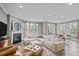 Inviting living room with neutral sectional sofa, fireplace, and views into the dining area at 1527 Ingraham Dr, Apex, NC 27502