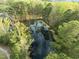Aerial view of a serene pond surrounded by lush green trees, creating a peaceful atmosphere at 1527 Ingraham Dr, Apex, NC 27502