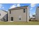 The home's backyard features new sod, a sliding glass door and vinyl siding at 200 Olive Branch St, Sanford, NC 27332