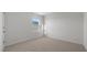 A bright bedroom features neutral carpet, white walls, and a large window at 200 Olive Branch St, Sanford, NC 27332