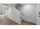 Hallway with hardwood floors and a staircase leading to the upper level of the home at 200 Olive Branch St, Sanford, NC 27332