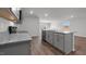 Modern kitchen featuring an island, white cabinets, stainless steel appliances, and vinyl floors at 200 Olive Branch St, Sanford, NC 27332