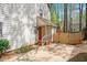 Charming backyard with a vibrant red door, driveway, and a fenced gate at 202 Lighthouse Way, Cary, NC 27511