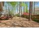 Spacious backyard with mature trees, wooden deck, and a privacy fence at 202 Lighthouse Way, Cary, NC 27511