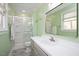 Well-lit bathroom with a glass-enclosed shower, vanity, and a large mirror at 202 Lighthouse Way, Cary, NC 27511