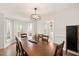 This dining room features hardwood floors, views to the backyard and an arched doorway to the kitchen at 202 Lighthouse Way, Cary, NC 27511