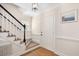 Inviting foyer featuring hardwood floors, staircase with black banister and a classic front door at 202 Lighthouse Way, Cary, NC 27511