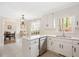Kitchen with white cabinets, quartz countertops, stainless steel appliances and a view to the dining room at 202 Lighthouse Way, Cary, NC 27511