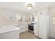 Bright kitchen featuring white cabinets, quartz countertops, stainless steel appliances and a garden window at 202 Lighthouse Way, Cary, NC 27511