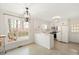 Bright kitchen with white cabinets, quartz countertops, stainless steel appliances and a garden view at 202 Lighthouse Way, Cary, NC 27511