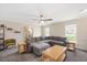 Comfortable living room with a plush gray sectional sofa, neutral walls and a view of the staircase at 202 Lighthouse Way, Cary, NC 27511