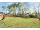 Large backyard featuring a wooden fence and mature trees at 2020 Battlewood Rd, Apex, NC 27523