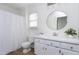 Clean bathroom featuring a shower, toilet, and vanity with white cabinets at 2020 Battlewood Rd, Apex, NC 27523