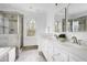 Bright bathroom with double sinks, soaking tub, separate shower, and neutral tile at 2020 Battlewood Rd, Apex, NC 27523