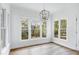 Bright dining area featuring large windows with a scenic view of the wooded backyard at 2020 Battlewood Rd, Apex, NC 27523