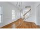 Entryway leading to stairs and dining room with hardwood floors and lots of natural light at 2020 Battlewood Rd, Apex, NC 27523
