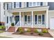 Charming home featuring a covered porch with white railing and blue shutters at 2020 Battlewood Rd, Apex, NC 27523
