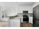 Bright kitchen features white cabinets, granite counters, stainless appliances, and stylish mosaic tile backsplash at 2020 Battlewood Rd, Apex, NC 27523