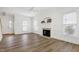Bright living room with a fireplace, hardwood floors, and large windows at 2020 Battlewood Rd, Apex, NC 27523