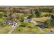 Expansive aerial shot of the home showcasing lush landscaping, mature trees, and multiple outbuildings at 206 Herronwood Dr, Graham, NC 27253