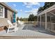 Backyard with a screened patio and wood deck that is complete with comfortable seating and an umbrella at 206 Herronwood Dr, Graham, NC 27253