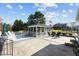 Backyard patio with a screened gazebo, outdoor seating, and a well-maintained lawn at 206 Herronwood Dr, Graham, NC 27253