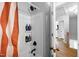 A simple bathtub and shower combination with bronze fixtures and a partial shower curtain at 206 Herronwood Dr, Graham, NC 27253
