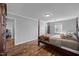 Bedroom with hardwood floors, four-poster bed, and natural light at 206 Herronwood Dr, Graham, NC 27253