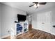 Bedroom featuring a large television on a bookshelf next to closet doors and wood-look flooring at 206 Herronwood Dr, Graham, NC 27253