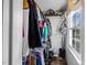 Closet with hanging clothes, shelving, and a window for natural light at 206 Herronwood Dr, Graham, NC 27253
