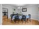 Traditional dining room with hardwood floors, a modern chandelier and a set dining table at 206 Herronwood Dr, Graham, NC 27253