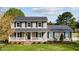 Charming two-story home with a welcoming front porch, black shutters, and a well-maintained lawn at 206 Herronwood Dr, Graham, NC 27253