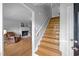 View of the foyer with a staircase leading upstairs and a glimpse into the cozy living room at 206 Herronwood Dr, Graham, NC 27253
