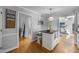 Kitchen island with stone countertop, with a partial view of the gym room, and decorative signs at 206 Herronwood Dr, Graham, NC 27253