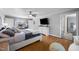 Main bedroom with hardwood floors, a large window and a flat screen tv at 206 Herronwood Dr, Graham, NC 27253