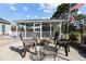 Outdoor screened patio area featuring a fire pit and outdoor furniture at 206 Herronwood Dr, Graham, NC 27253