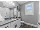 This bathroom features a gray quartz countertop and white cabinets and a tiled shower at 207 Grand Ave, Raleigh, NC 27606