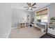 This bedroom features neutral carpet and a ceiling fan with a desk and bookcase at 207 Grand Ave, Raleigh, NC 27606