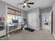 This bedroom has neutral carpet and a ceiling fan with a desk and a closet at 207 Grand Ave, Raleigh, NC 27606