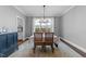 Formal dining room with modern chandelier, neutral walls, and views to the backyard is perfect for entertaining at 207 Grand Ave, Raleigh, NC 27606