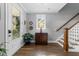 Welcoming entryway with hardwood floors, staircase, decorative chest, and natural light creates an inviting ambiance at 207 Grand Ave, Raleigh, NC 27606